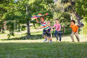 Children playing with kite in park