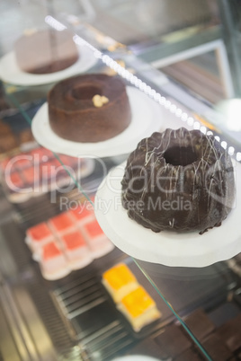 Display case with chocolate cakes
