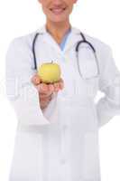 Smiling doctor offering an apple