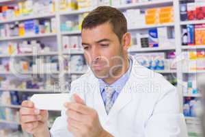 Handsome pharmacist holding paper