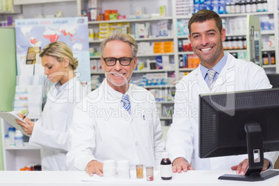 Team of pharmacists smiling at camera