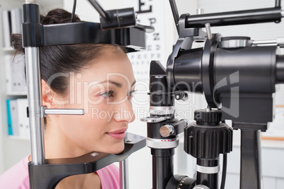 Female patient looking into slit lamp