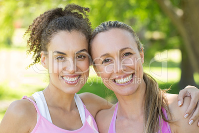 Smiling women in pink for breast cancer awareness