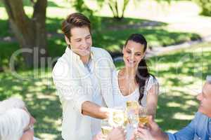 Happy couple toasting with their family