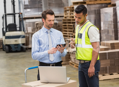 Warehouse worker talking with his manager