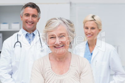 Senior patient smiling with doctors in clinic
