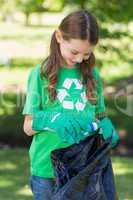 Happy little girl collecting rubbish