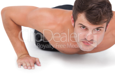 Fit shirtless man doing push ups