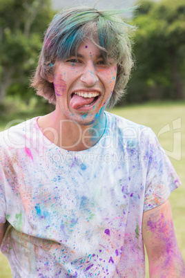 Young man having fun with powder paint