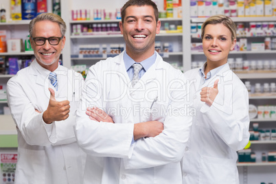 Team of pharmacists smiling at camera