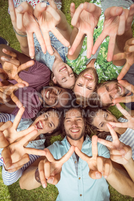 Happy young friends lying on grass