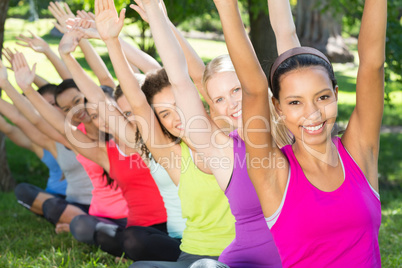 Fitness group doing yoga in park