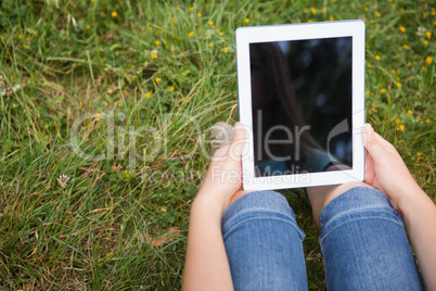 Woman using tablet in park