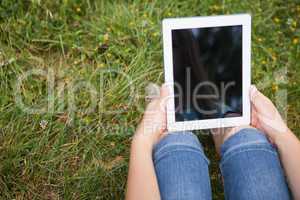 Woman using tablet in park