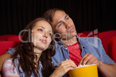 Young couple watching a film