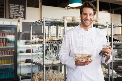 Cheerful baker holding coffee house and food