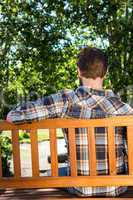 Handsome hipster relaxing in the park