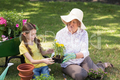 Happy grandmother with her granddaughter gardening