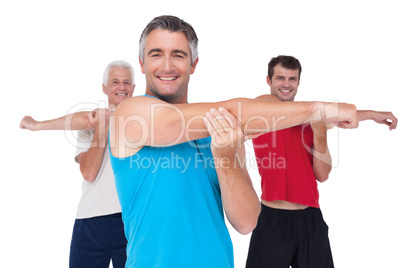 Fit men stretching their arms