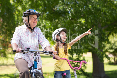 Happy grandmother with her granddaughter on their bike