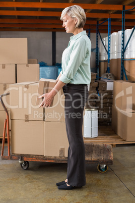 Warehouse manager holding cardboard box