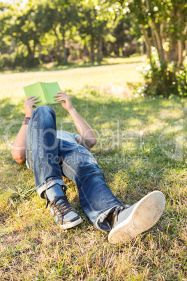 Young man reading book in the park