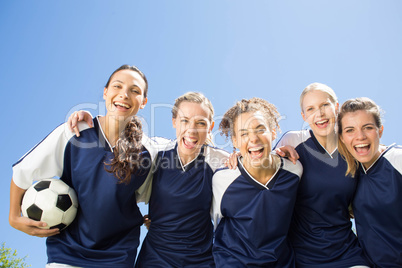 Pretty football players smiling at camera