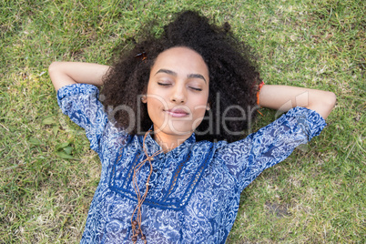 Pretty young woman napping in park