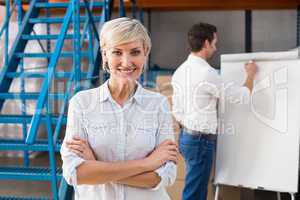 Warehouse manager smiling at camera