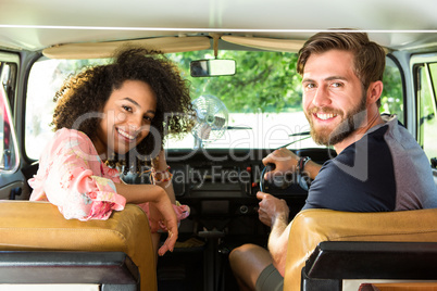 Hipster couple driving in camper van