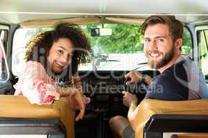 Hipster couple driving in camper van