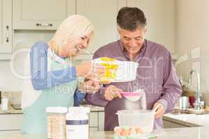 Happy mature couple baking together