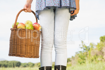 Woman holding basket of apples