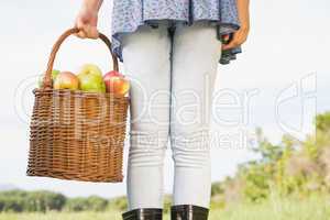 Woman holding basket of apples