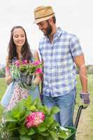 Happy young couple gardening together