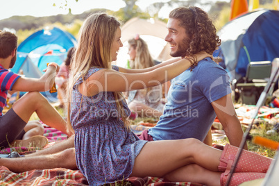 Hipster couple smiling at each other