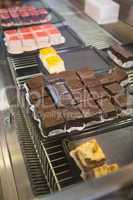 Display case with brownies and sweet cakes