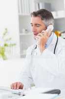 Doctor using computer while on call
