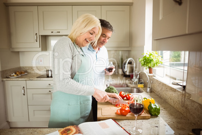 Mature couple preparing vegetables together