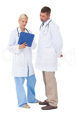 Doctors discussing something on clipboard