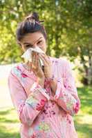 Pretty brunette blowing her nose