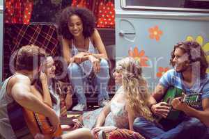 Hipster friends by camper van at festival