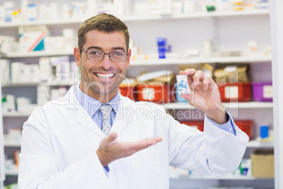 Pharmacist showing medicine jar