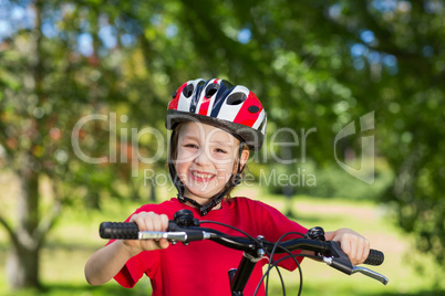 Happy little boy on his bike