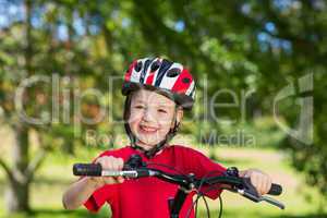 Happy little boy on his bike
