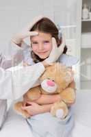 Doctor making plaster in little girl