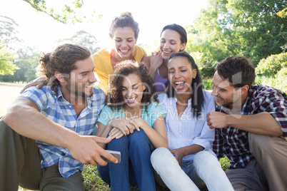 Smiling friends in the park taking selfie