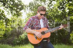 Handsome hipster playing the guitar