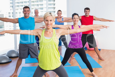 Instructor with class exercising in fitness club