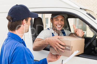 Delivery driver handing parcel to customer in his van